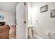 Tastefully designed half bathroom with pedestal sink, modern lighting, and decorative wall art at 2820 Oakwater Dr # 2820, Kissimmee, FL 34747