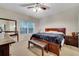 Bedroom with neutral carpet, natural lighting, and matching nightstands and furniture at 2820 Oakwater Dr # 2820, Kissimmee, FL 34747