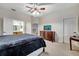 Primary bedroom featuring a dresser with TV, carpet flooring and adjoining bathroom at 2820 Oakwater Dr # 2820, Kissimmee, FL 34747