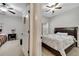 Bedrooms with ceiling fans and carpets. One with a brown leather frame and the other with red covers at 2820 Oakwater Dr # 2820, Kissimmee, FL 34747
