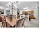 Dining room area featuring a long wooden table and chairs with an adjacent kitchen view at 2820 Oakwater Dr # 2820, Kissimmee, FL 34747
