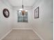 Dining room with tiled floor and a chandelier and a window with blinds at 2820 Oakwater Dr # 2820, Kissimmee, FL 34747