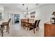 Elegant dining room with wooden table, upholstered chairs, chandelier, and sliding glass doors to the patio at 2820 Oakwater Dr # 2820, Kissimmee, FL 34747