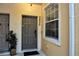 Close-up of unit entrance with a gray door, a window and address number at 2820 Oakwater Dr # 2820, Kissimmee, FL 34747