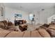 Inviting living room with comfortable seating, entertainment center, and neutral tile flooring at 2820 Oakwater Dr # 2820, Kissimmee, FL 34747