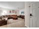 Comfortable living room with a large brown sectional sofa, a TV, and light-colored tile flooring at 2820 Oakwater Dr # 2820, Kissimmee, FL 34747
