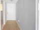 Clean hallway with wood-look floors and neutral paint, leading to the front door at 2850 N Powers Dr # 74, Orlando, FL 32818