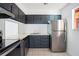 Efficient kitchen layout with stainless steel appliances, including a refrigerator and electric range at 2850 N Powers Dr # 74, Orlando, FL 32818