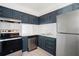 Modern kitchen featuring stainless steel appliances, navy cabinets and white subway tile backsplash at 2850 N Powers Dr # 74, Orlando, FL 32818