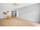 Open-concept living room with wood-look floors, ceiling fan, modern light fixture, and pass-through to kitchen at 2850 N Powers Dr # 74, Orlando, FL 32818