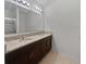 Elegant bathroom with double sinks, granite countertop, modern lighting, and sleek fixtures at 326 Charles Dr, Deland, FL 32724