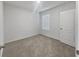 Bright bedroom featuring carpet, a window and a white door at 326 Charles Dr, Deland, FL 32724