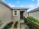 Inviting front entrance with a walkway, landscaping, and a neutral-colored exterior at 326 Charles Dr, Deland, FL 32724