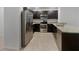 Modern kitchen featuring stainless steel appliances, dark wood cabinets, and granite countertops at 326 Charles Dr, Deland, FL 32724