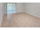 Open living room with tile flooring and sliding glass doors to the lanai at 326 Charles Dr, Deland, FL 32724