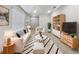 Bright living room featuring a modern design with neutral tones, striped accents, and stylish furniture at 326 Charles Dr, Deland, FL 32724