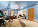 Bedroom featuring blue walls, a ceiling fan, and natural light from a window at 3580 Ne 160Th Ln, Citra, FL 32113