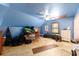Bedroom featuring blue walls, a ceiling fan, and natural light from a window at 3580 Ne 160Th Ln, Citra, FL 32113