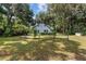 Quaint light blue home in the trees with a fenced yard and visible address for convenient identification at 3580 Ne 160Th Ln, Citra, FL 32113