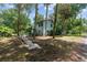 Light blue, two-story home surrounded by tall trees and lush greenery offers a serene, private setting at 3580 Ne 160Th Ln, Citra, FL 32113