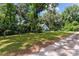 Quaint light blue home surrounded by lush trees and plants, creating a serene atmosphere at 3580 Ne 160Th Ln, Citra, FL 32113