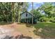Back view of light blue home with surrounding tall trees, plants, and greenery on an expansive lot at 3580 Ne 160Th Ln, Citra, FL 32113