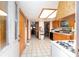 Spacious kitchen has wood cabinets, white appliances, and an exit door at 3580 Ne 160Th Ln, Citra, FL 32113