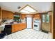 Bright kitchen features wood cabinets, white appliances, and light colored tile floors at 3580 Ne 160Th Ln, Citra, FL 32113
