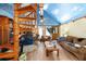 Open concept living room with spiral staircase, fireplace, and cloud-themed ceiling at 3580 Ne 160Th Ln, Citra, FL 32113