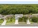 An aerial view of a lovely home with lush trees surrounding the neighborhood and spacious lawns at 3610 Doe Run Dr, St Cloud, FL 34772