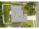 An aerial view highlights the home's backyard, roof, and the surrounding green landscape at 3610 Doe Run Dr, St Cloud, FL 34772