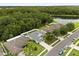 An aerial view showcases the home's proximity to a tranquil lake and lush, green landscaping at 3610 Doe Run Dr, St Cloud, FL 34772