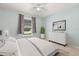Light and airy bedroom featuring neutral walls, carpeted floor, a large bed, and a sunny window at 3610 Doe Run Dr, St Cloud, FL 34772