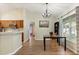 Cozy dining area with modern chandelier, natural light, and wood-look flooring at 3610 Doe Run Dr, St Cloud, FL 34772