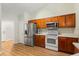Bright kitchen with ample wood cabinets, stainless steel refrigerator, and wood-look floors at 3610 Doe Run Dr, St Cloud, FL 34772