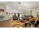 Spacious living room with wood floors flowing into adjacent dining area and kitchen at 3610 Doe Run Dr, St Cloud, FL 34772