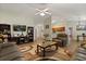 Open-concept living room showcasing wood floors, neutral walls, and seamless flow to the kitchen at 3610 Doe Run Dr, St Cloud, FL 34772