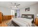 Serene main bedroom with wood flooring, neutral tones, ensuite bathroom, and ample natural light at 3610 Doe Run Dr, St Cloud, FL 34772