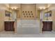 Elegant bathroom featuring a large soaking tub, dual vanities, decorative mirrors, and modern lighting fixtures at 3798 Lower Union Rd, Orlando, FL 32814