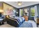 Stylish bedroom showcases a large decorative painting, a plush rug, and plenty of natural light at 3798 Lower Union Rd, Orlando, FL 32814