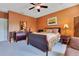 Comfortable bedroom features a wooden bed, vibrant walls, and soft carpet, providing a relaxing ambiance at 3798 Lower Union Rd, Orlando, FL 32814