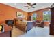 Spacious bedroom with natural light showcases a comfortable sofa, wooden furnishings, and decorative accents at 3798 Lower Union Rd, Orlando, FL 32814