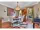 Elegant dining room featuring hardwood floors, modern lighting, and stylish decor at 3798 Lower Union Rd, Orlando, FL 32814
