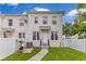 Townhouse featuring a well-maintained lawn, white fence and a charming walkway at 3798 Lower Union Rd, Orlando, FL 32814