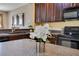 Modern kitchen featuring dark cabinets, a speckled countertop, and a decorative white flower arrangement at 3798 Lower Union Rd, Orlando, FL 32814