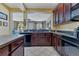 Kitchen with an island, black appliances, and seamless access to the living area at 3798 Lower Union Rd, Orlando, FL 32814
