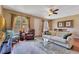Comfortable living room features a plush sofa, hardwood floors with area rug, and ample natural light at 3798 Lower Union Rd, Orlando, FL 32814