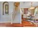 Stairway leading to upper level, with hardwood floors, adjacent dining area and decorative wall art at 3798 Lower Union Rd, Orlando, FL 32814