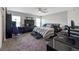 Spacious bedroom features a large bed, ceiling fan, and ample natural light, creating a cozy and inviting atmosphere at 394 Pentas Ln, Haines City, FL 33844