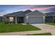 Charming single-story home with a well-manicured lawn and a two-car garage, perfect for a growing Gathering at 394 Pentas Ln, Haines City, FL 33844